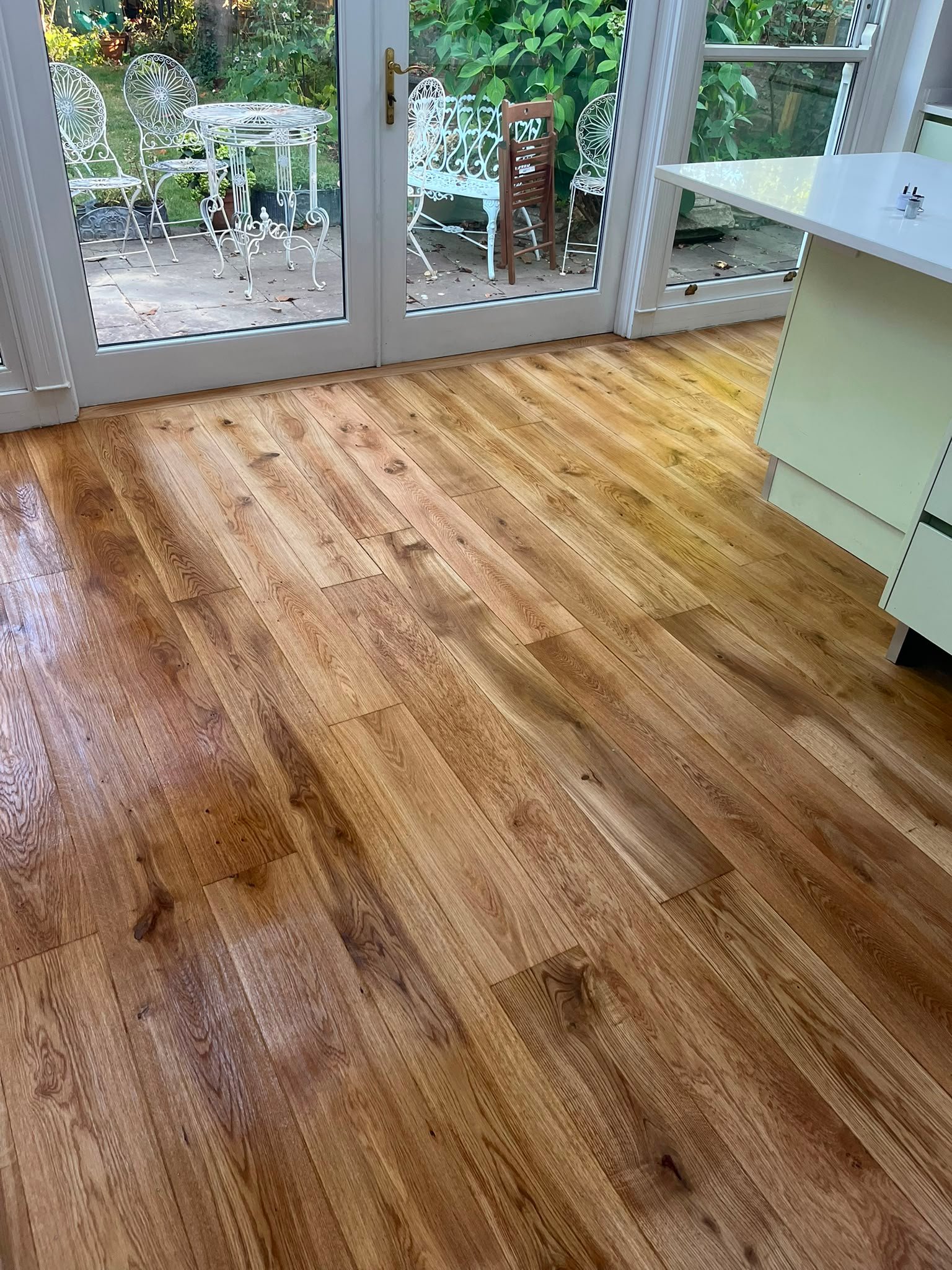 Oak plank floor fitted through a kitchen