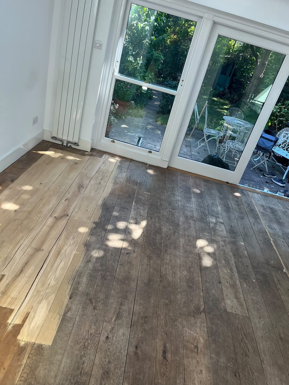 New oak boards laid beside the old floor
