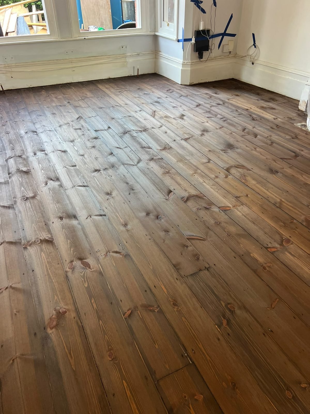 Pine floor restoration in a bay-window room