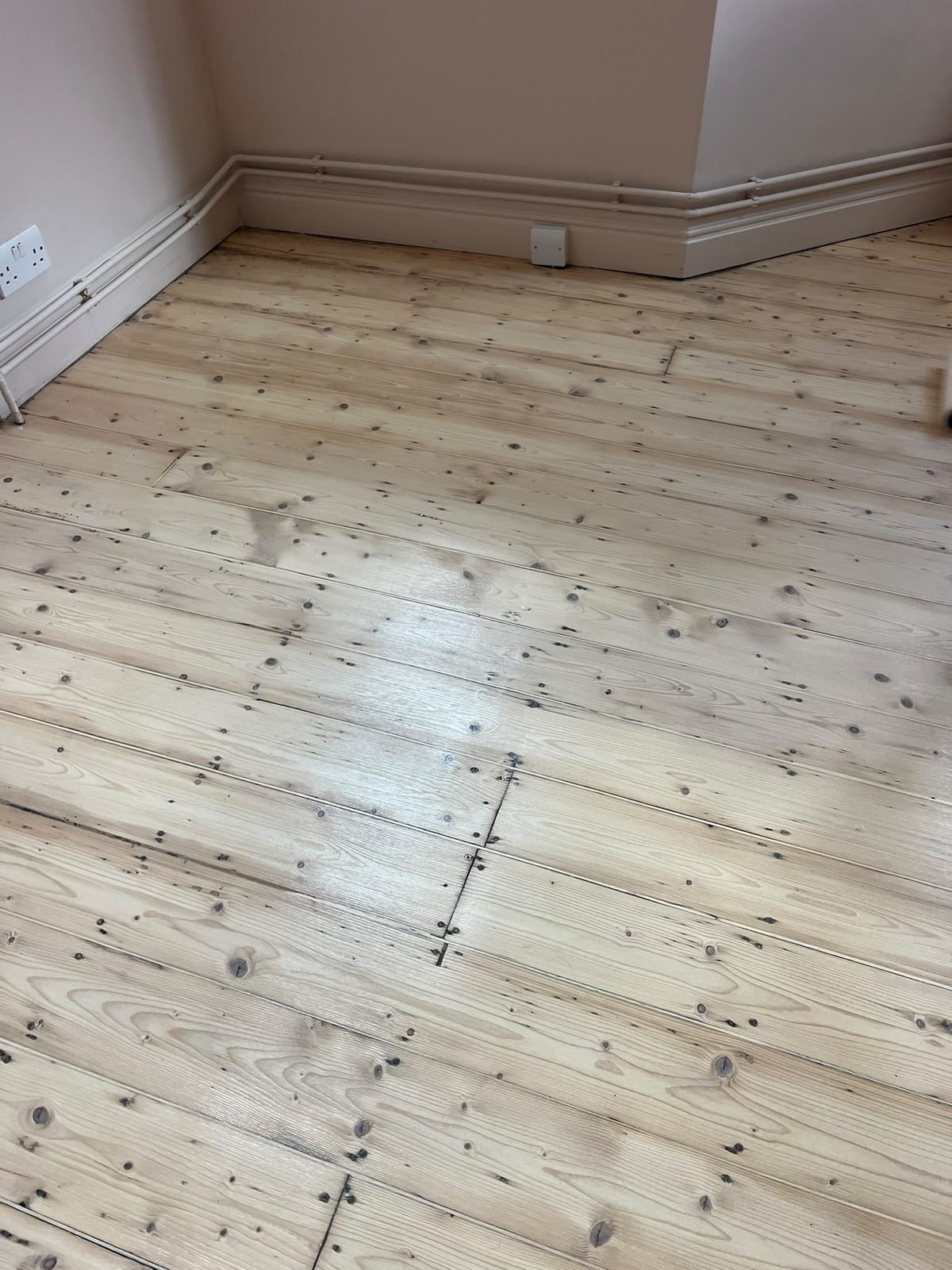 Pine floor with replacement boards blended into the original