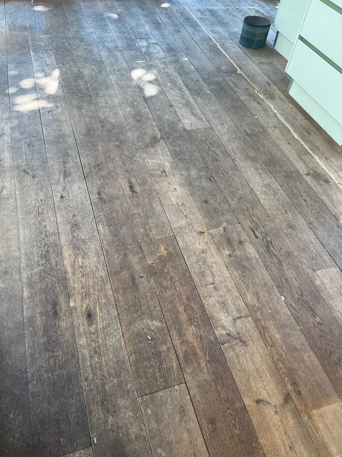 Grey weathered pine floorboards before sanding