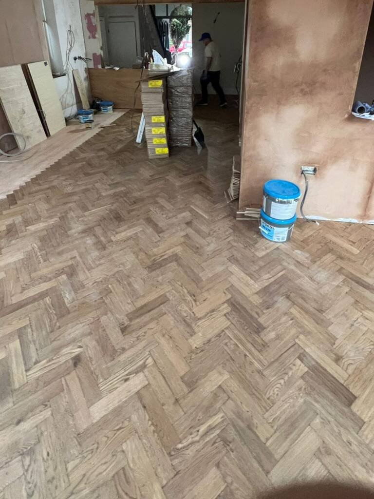 Parquet blocks stacked ready as a herringbone floor is fitted