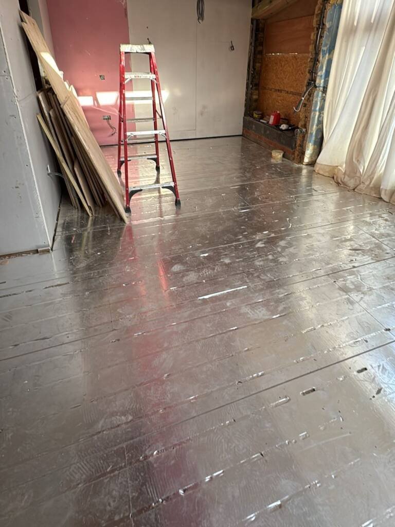Levelled and sealed subfloor prepared before parquet blocks are laid