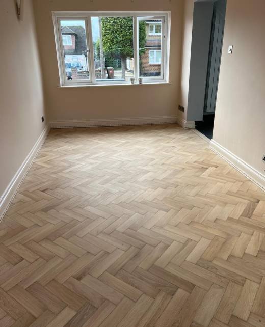 Light oak herringbone floor fitted in a bay window living room